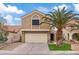 Two-story house with a beige exterior, attached garage, and palm tree landscaping at 3321 Mariner Bay St, Las Vegas, NV 89117