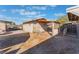 Backyard view of a modest single story home, partially fenced and with dirt and gravel landscaping at 3327 Rio Grande St, Las Vegas, NV 89115