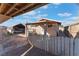 A backyard shed and car port feature wooden privacy fences and plenty of space for parking at 3327 Rio Grande St, Las Vegas, NV 89115