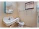 A modest bathroom features a white sink and toilet, basic fixtures, and a window for natural light at 3327 Rio Grande St, Las Vegas, NV 89115