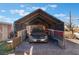 Open carport featuring a brick-paved floor providing sheltered parking for vehicles and storage space at 3327 Rio Grande St, Las Vegas, NV 89115