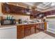 Functional kitchen featuring dark cabinets, essential appliances, and ample countertop space at 3327 Rio Grande St, Las Vegas, NV 89115