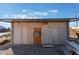 A backyard shed with a metal roof, weathered siding and an air conditioning unit at 3327 Rio Grande St, Las Vegas, NV 89115