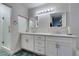 Bathroom featuring a double vanity, framed mirrors, and a glass door shower at 3663 Laguna Verde Way, Las Vegas, NV 89121