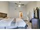 Bedroom featuring a ceiling fan, high ceilings, carpet, and a view into the bathroom and hall at 3663 Laguna Verde Way, Las Vegas, NV 89121