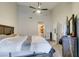 Bedroom featuring a ceiling fan, high ceilings, carpet, and a view into the bathroom and hall at 3663 Laguna Verde Way, Las Vegas, NV 89121