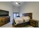 Bedroom with high ceilings, neutral carpet, ceiling fan, and dark wood furniture at 3663 Laguna Verde Way, Las Vegas, NV 89121