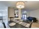 Open-concept dining area showcases wood floors and a view into the living room and kitchen at 3663 Laguna Verde Way, Las Vegas, NV 89121