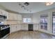 Spacious kitchen featuring stainless appliances, white cabinets, quartz countertops, and ample light at 3663 Laguna Verde Way, Las Vegas, NV 89121