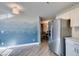 Kitchen leading to a dining area, featuring a stainless steel refrigerator and stylish flooring at 3663 Laguna Verde Way, Las Vegas, NV 89121