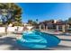 Community pool surrounded by lounge chairs and landscaped grounds at 3663 Laguna Verde Way, Las Vegas, NV 89121