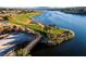 Aerial view of a golf course with a lake and walking bridge at 38 Strada Principale, Henderson, NV 89011