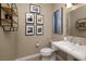 Elegant powder room with pedestal sink and framed art at 38 Strada Principale, Henderson, NV 89011