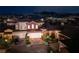 Night view of a residential home with attached garage and landscaping at 38 Strada Principale, Henderson, NV 89011