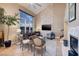 Living room with high ceilings, stone fireplace and large windows at 38 Strada Principale, Henderson, NV 89011