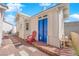 Charming exterior building with bright blue doors, providing additional space, set in a landscaped backyard at 3923 Gramercy Ave, North Las Vegas, NV 89031