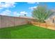 Well-maintained backyard with lush artificial grass, complemented by tasteful picket fencing for added charm at 3923 Gramercy Ave, North Las Vegas, NV 89031