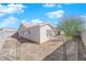 Back exterior view of home surrounded by dirt yard waiting for the new homeowner's personal touch at 3923 Gramercy Ave, North Las Vegas, NV 89031