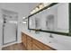 Bathroom with double sinks, framed mirror, and a glass-enclosed shower provides spa-like tranquility at 3923 Gramercy Ave, North Las Vegas, NV 89031