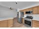 Modern kitchen equipped with stainless steel appliances, wooden cabinets, and a white countertop island at 3923 Gramercy Ave, North Las Vegas, NV 89031