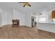 Open-concept living room featuring a stone fireplace, wood-look floors, and kitchen view at 3923 Gramercy Ave, North Las Vegas, NV 89031