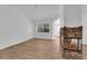 Comfortable living room featuring a stone fireplace, wood-look flooring, and natural light from a large window at 3923 Gramercy Ave, North Las Vegas, NV 89031