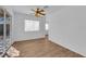 Bright, airy living room with wood-look flooring, ceiling fan, and access to outdoor spaces at 3923 Gramercy Ave, North Las Vegas, NV 89031