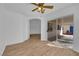 Open-plan living area with sliding glass doors and wood-style floors, brightened by a ceiling fan at 3923 Gramercy Ave, North Las Vegas, NV 89031