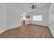 Bright living room featuring wood-look tile flooring, a ceiling fan, and an open view of the kitchen at 3923 Gramercy Ave, North Las Vegas, NV 89031