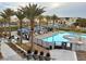 Community pool with cabanas, lounge chairs, and palm trees surrounded by manicured landscaping and walkways at 4342 Guava Ct # 0, Las Vegas, NV 89135