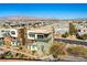 Three-story home showcasing balconies, desert landscaping, and a mountain view at 4342 Guava Ct # 0, Las Vegas, NV 89135