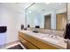 Bright bathroom with a double vanity, stone countertop, and large mirror at 4929 Summit Overlook Dr, Las Vegas, NV 89135