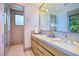 Modern bathroom featuring double vanities, a walk-in shower, and elegant fixtures at 4929 Summit Overlook Dr, Las Vegas, NV 89135