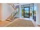 Bright, open foyer with a floating staircase and glass railing at 4929 Summit Overlook Dr, Las Vegas, NV 89135