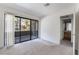 Sunlit bedroom with sliding glass door to a balcony at 5046 S Rainbow Blvd # 103, Las Vegas, NV 89118