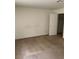 Simple carpeted bedroom with a closet and door at 5046 S Rainbow Blvd # 103, Las Vegas, NV 89118