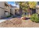 Exterior view of apartment complex featuring trees and rock landscaping at 5046 S Rainbow Blvd # 103, Las Vegas, NV 89118