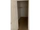 Simple closet with a hanging rod and carpeted floor at 5046 S Rainbow Blvd # 103, Las Vegas, NV 89118