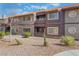 Two-story condo building with balconies, desert landscaping and a red tile roof offers a low-maintenance lifestyle at 5046 S Rainbow Blvd # 103, Las Vegas, NV 89118