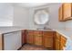 Cozy kitchen featuring wood cabinets, stainless steel sink, and a window providing natural light at 5046 S Rainbow Blvd # 103, Las Vegas, NV 89118