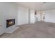 Large living room with a fireplace with the fire on, neutral paint, and carpet at 5046 S Rainbow Blvd # 103, Las Vegas, NV 89118