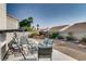 Landscaped backyard with patio furniture and a covered swing at 5448 Red Sun Dr, Las Vegas, NV 89149