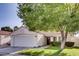 Single-story house with a white exterior, brown tile roof, and a well-manicured lawn at 5448 Red Sun Dr, Las Vegas, NV 89149