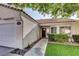 House exterior showcasing a walkway to the entrance, neatly landscaped lawn, and a two-car garage at 5448 Red Sun Dr, Las Vegas, NV 89149