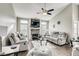 Living room with vaulted ceilings, a stone fireplace, and comfortable seating arrangement at 5448 Red Sun Dr, Las Vegas, NV 89149