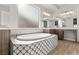 Elegant bathroom with double vanity, soaking tub, and patterned tile at 5860 Noah Springs Ct, Las Vegas, NV 89149