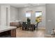 Bright dining room with wood table and gray chairs, overlooking pool at 5860 Noah Springs Ct, Las Vegas, NV 89149