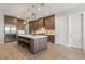 Modern kitchen with wood cabinets, quartz countertops, and island at 5860 Noah Springs Ct, Las Vegas, NV 89149