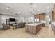 Modern kitchen with wood cabinets, quartz countertops, and island at 5860 Noah Springs Ct, Las Vegas, NV 89149