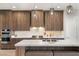 Gourmet kitchen boasting wood cabinets and a large marble island at 5860 Noah Springs Ct, Las Vegas, NV 89149